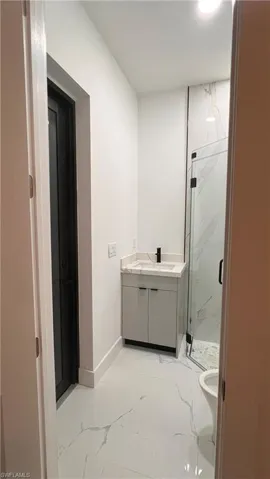 Bathroom with vanity, toilet, and walk in shower