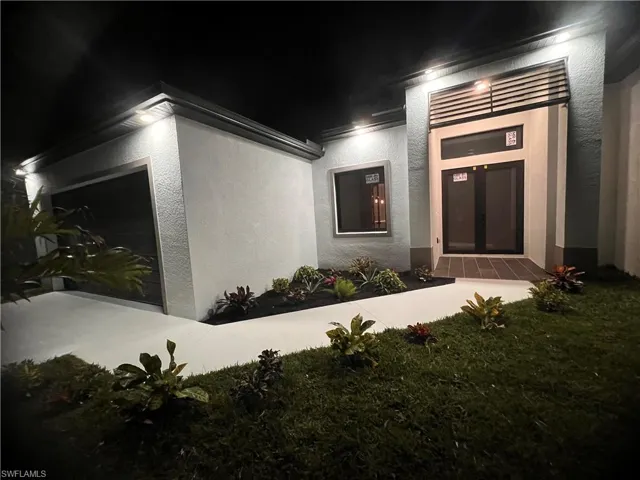 Property entrance featuring a lawn