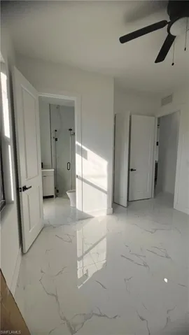 Empty room featuring ceiling fan