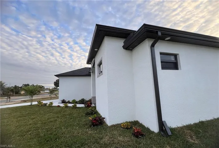 View of side of home featuring a lawn