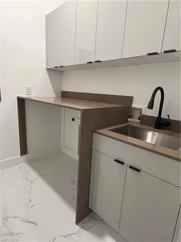 Kitchen with white cabinets and sink