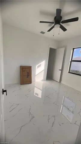 Empty room featuring ceiling fan