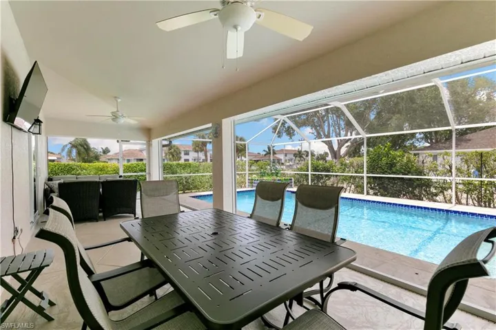 Large lanai has covered space for both dining and relaxing