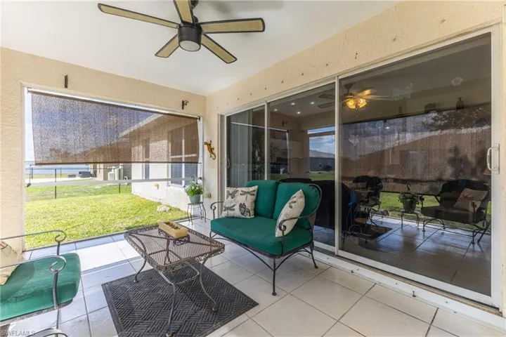 Sunroom / solarium with a ceiling fan and outdoor lounge area