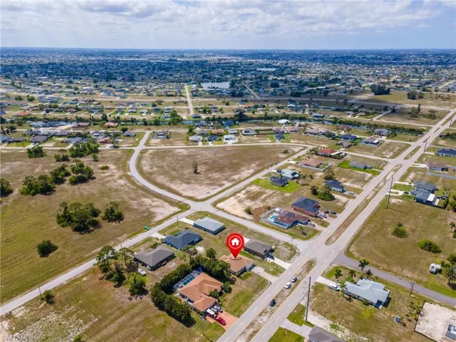 Aerial view of property's location featuring nearby suburban area
