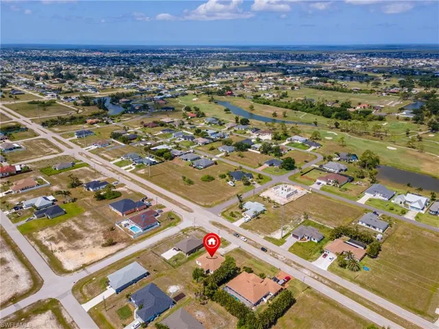 Aerial overview of property's location with a large body of water and nearby suburban area