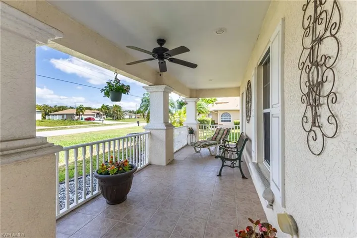 Covered porch featuring a ceiling fan