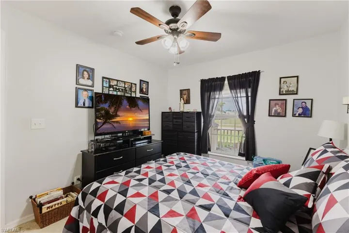 Bedroom featuring ceiling fan, access to outside, and carpet flooring