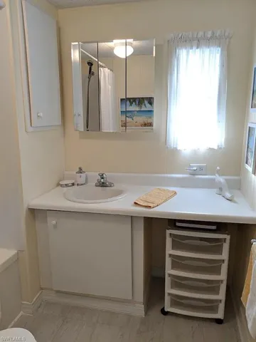 Full bath with vanity and curtained shower