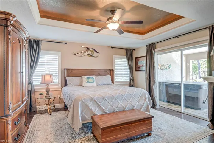 Wood Flooring, fireplace, trey ceilings and sliders out to the pool, hot tub and lanai