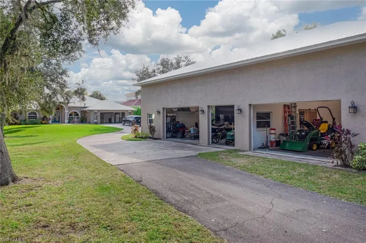 Three roll up garage doors on the side of the garage allowing for ample vehicles and toys or equipment