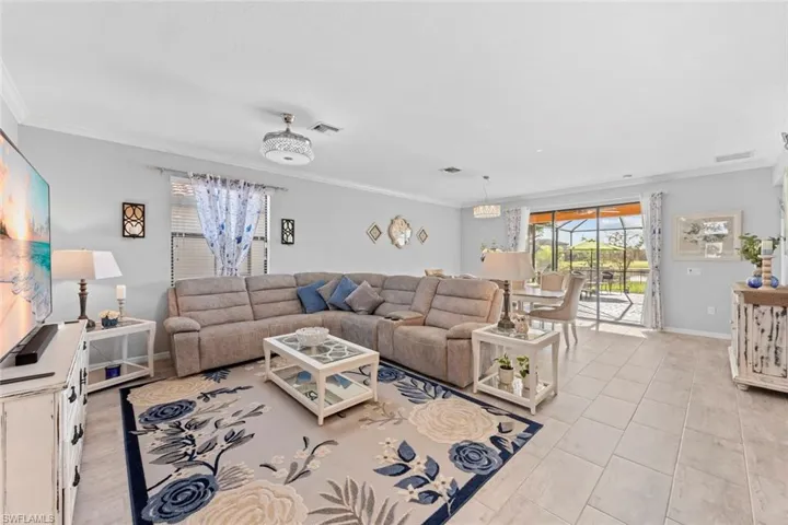 Tiled living room featuring crown molding