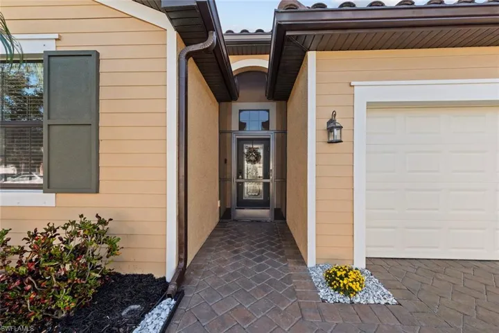 Doorway to property with a garage