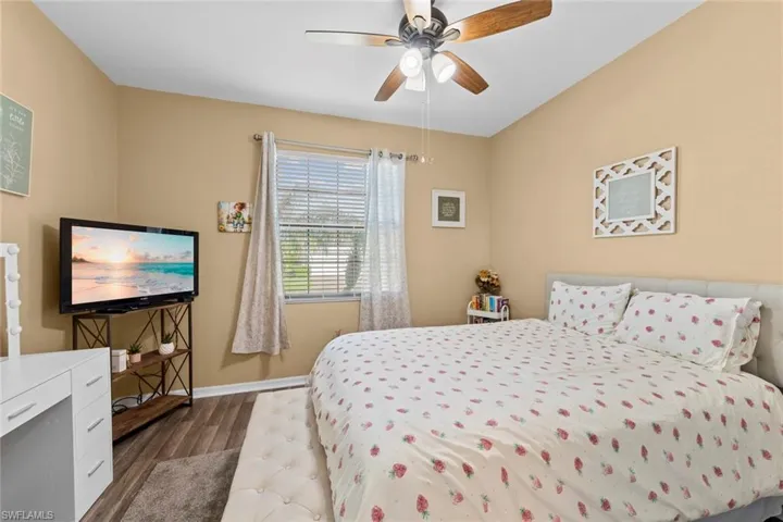 Bedroom with dark wood-type flooring and ceiling fan
