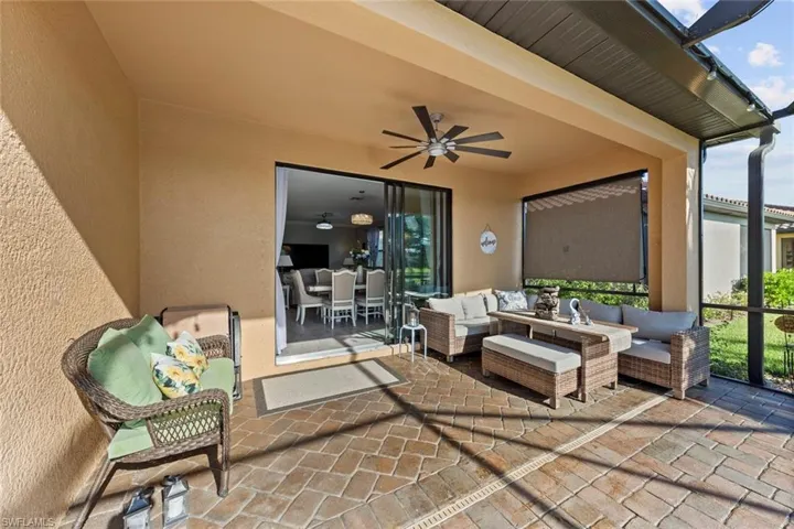 View of patio with an outdoor hangout area and ceiling fan