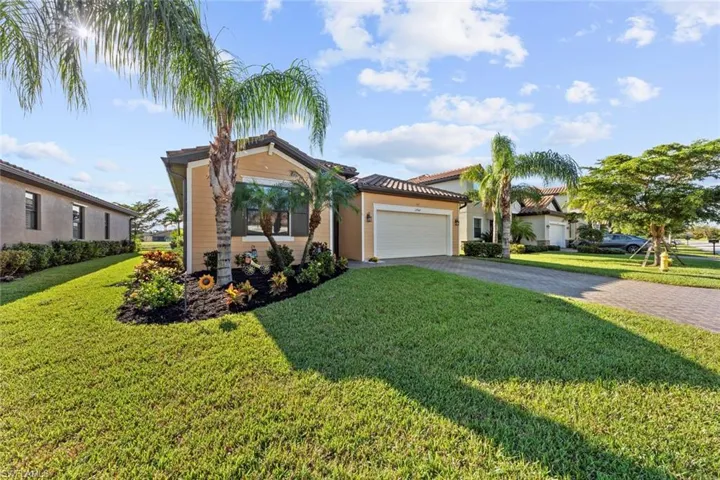 Mediterranean / spanish house with a garage and a front yard