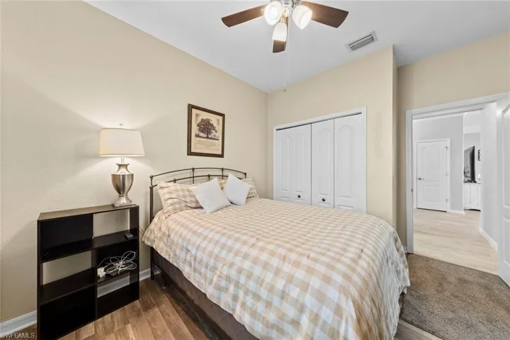 Bedroom featuring wood-type flooring, a closet, and ceiling fan