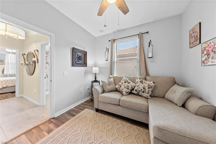 Living room with ceiling fan and wood-type flooring