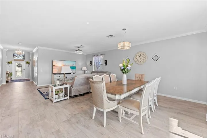 Dining area with crown molding and an inviting chandelier