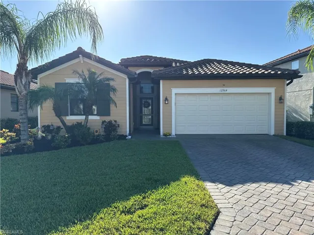 View of front of house with a front yard and a garage