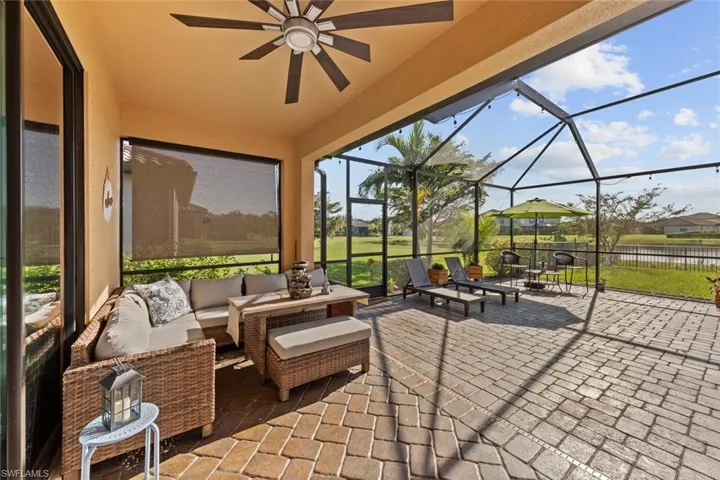 View of patio / terrace featuring an outdoor hangout area, glass enclosure, and ceiling fan