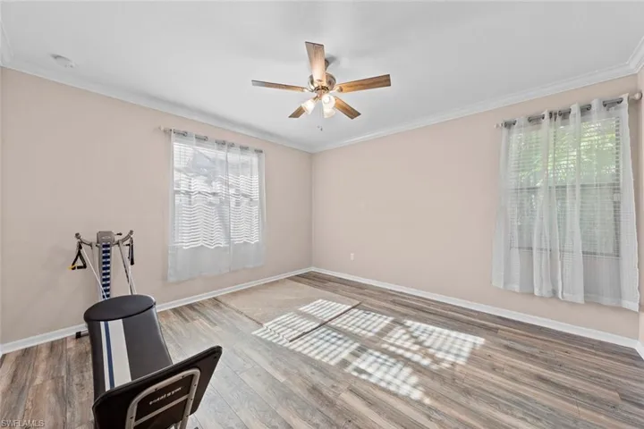 Sitting room featuring ornamental molding, hardwood / wood-style flooring, and ceiling fan