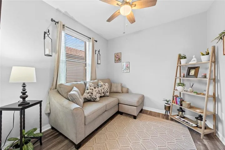 Living room featuring ceiling fan and wood-type flooring