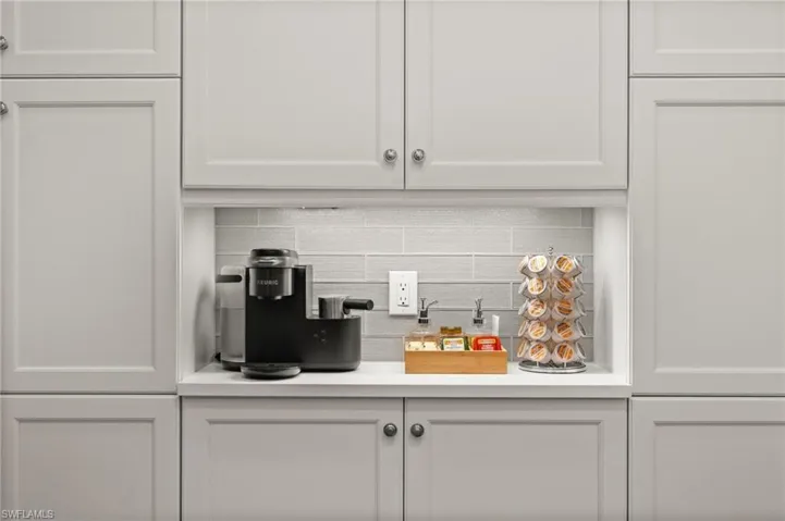 Bar area with light countertops and white cabinetry