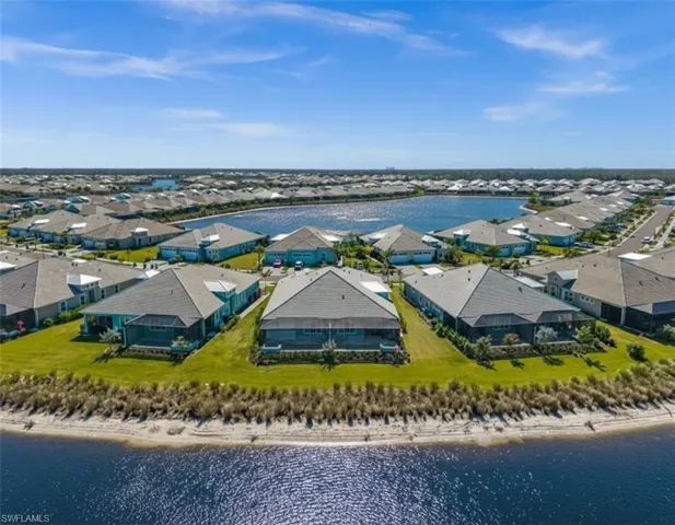 Aerial view of residential area with unending shoreline