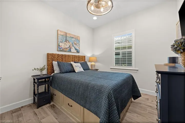 Bedroom with light wood-style floors and recessed lighting
