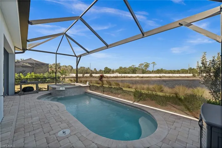 Combined pool / hot tub with a lanai, a patio area, and a sunroom