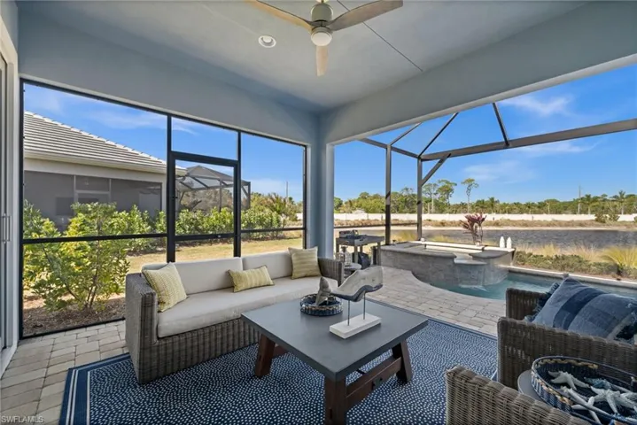 Sunroom / solarium featuring an outdoor hangout area, a jacuzzi, a ceiling fan, and a patio