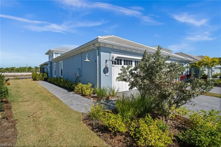 View of home's exterior with a yard, stucco siding, and an attached garage