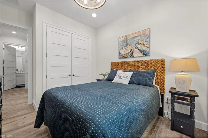 Bedroom with a closet, light wood-style floors, and recessed lighting