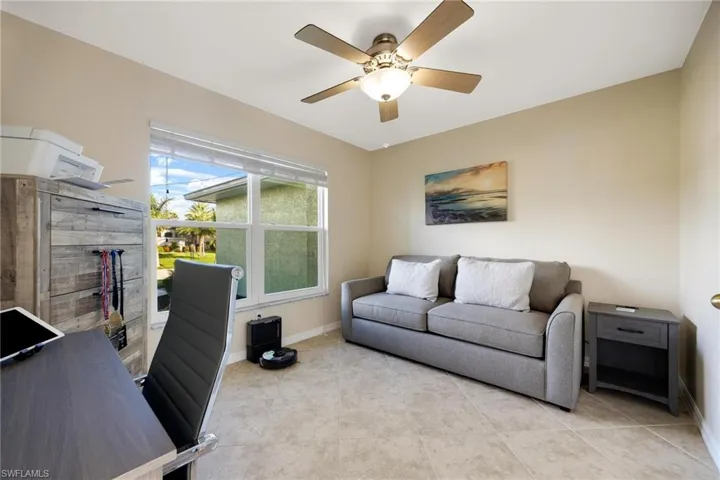 Tiled office featuring ceiling fan