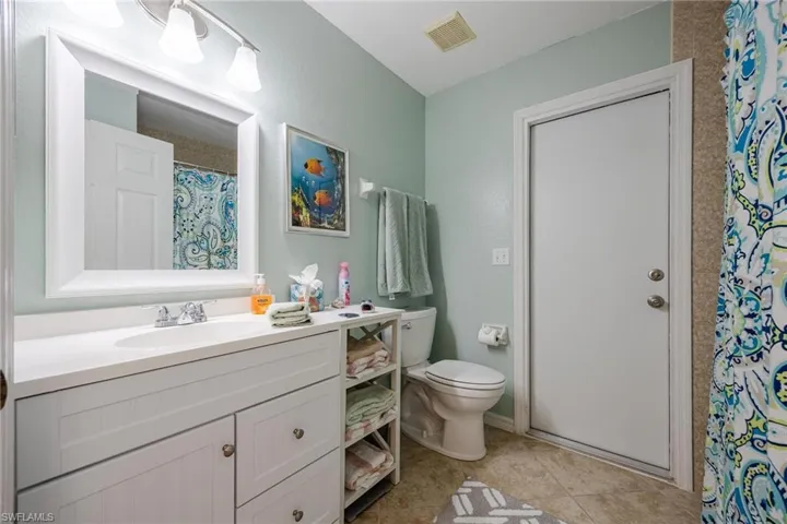 Bathroom with vanity, toilet, and tile patterned flooring