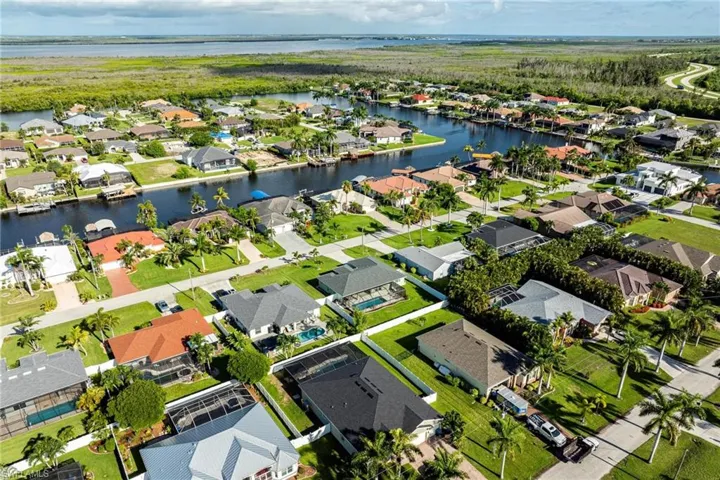 Birds eye view of property with a water view