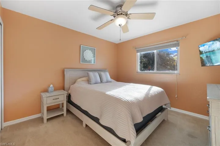 Bedroom with light carpet and ceiling fan