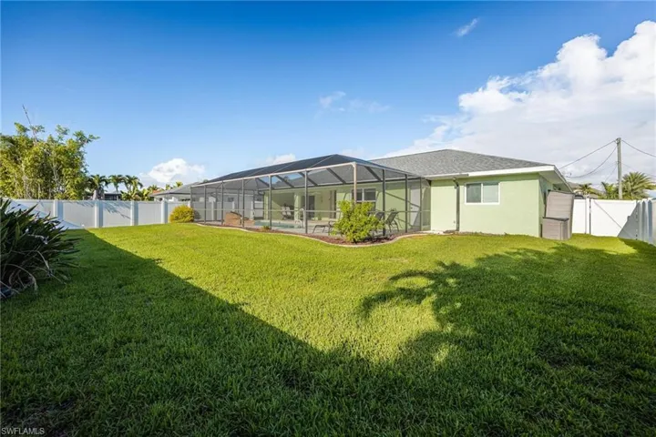 View of yard with glass enclosure