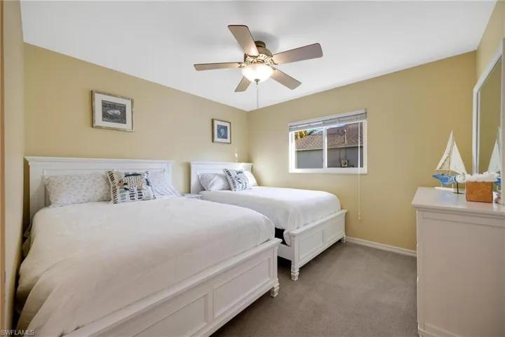 Carpeted bedroom with ceiling fan