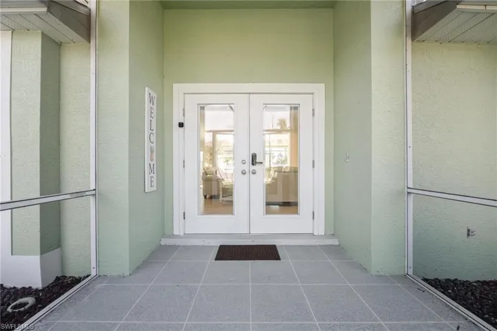 Doorway to property featuring french doors and elevator