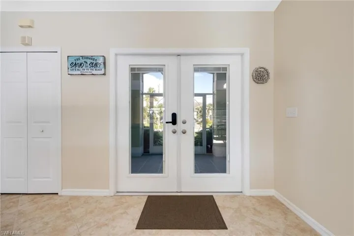 Doorway with french doors and tile patterned floors