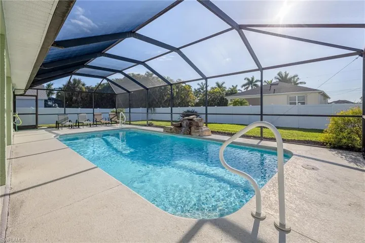 View of pool with a patio area and a lanai
