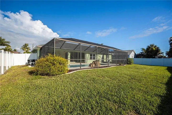 View of yard featuring a fenced in pool and a lanai