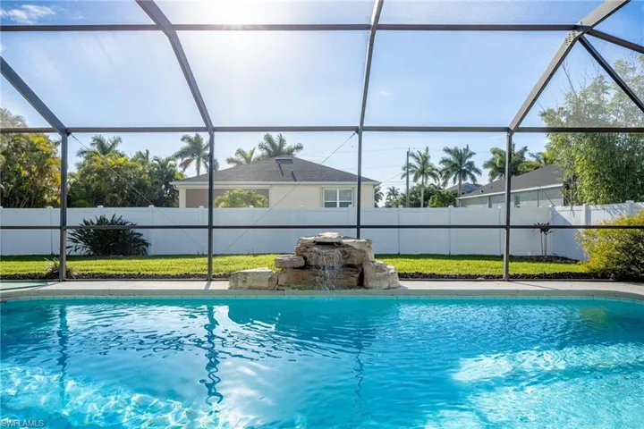 View of swimming pool with pool water feature and a lanai