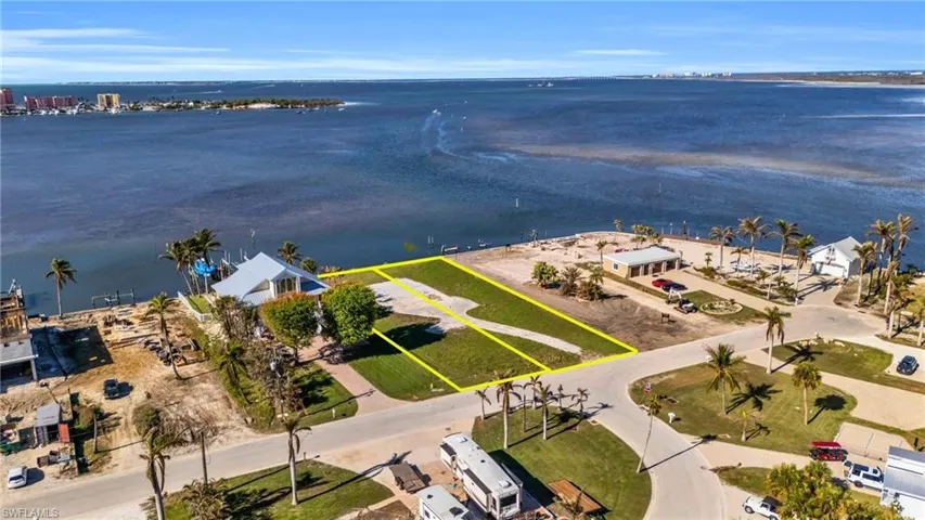 View of property location with a large body of water and property parcel outlined - Virtually Edited Image