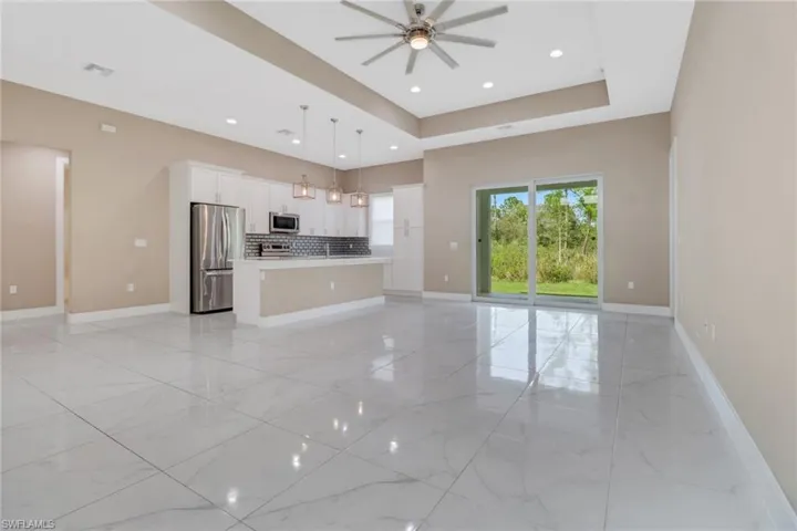 Bright and spacious living room with sliding glass door to lanai