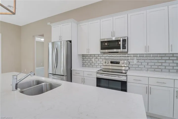 Light and bright kitchen featuring a center island - convenient for preparing and serving delicious snack and meals