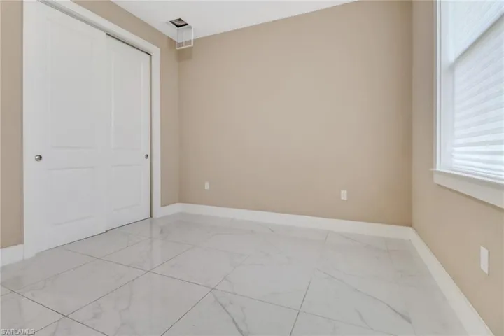 Guest bedroom one with wall closet