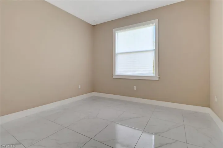 Guest bedroom one featuring tile flooring